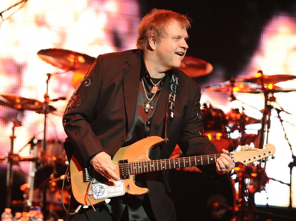 Photo of Meat Loaf in concert playing the guitar