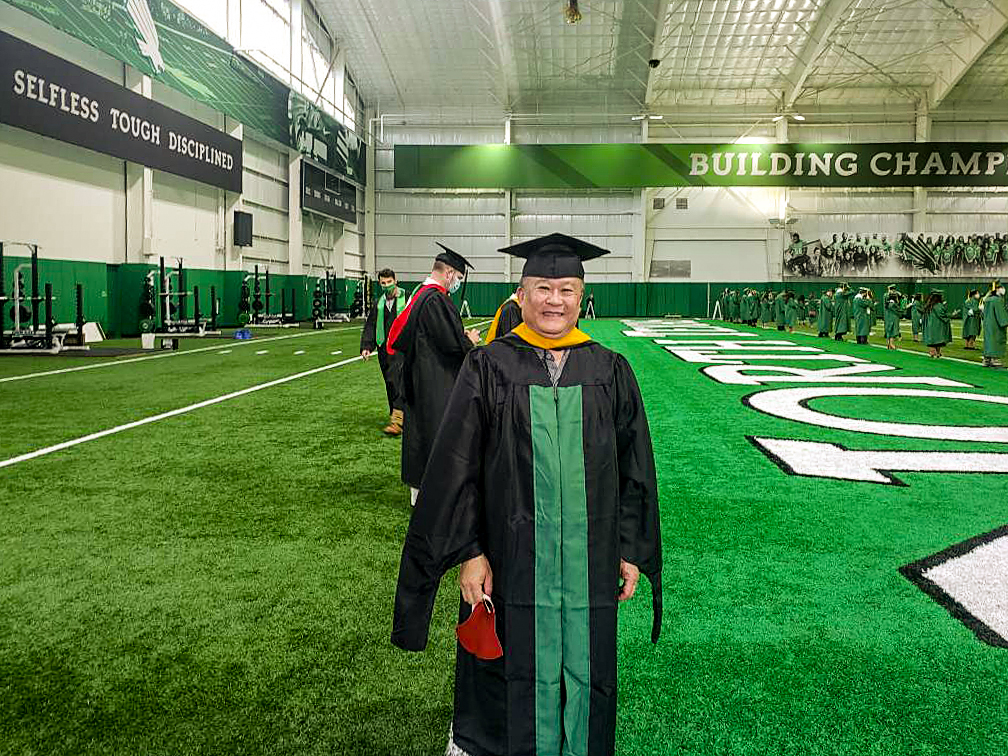Timothy Tran waits to take the field at Apogee Stadium during his Spring 2021 graduation.