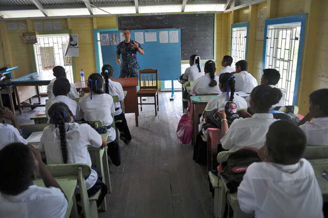 Lt. Mike Kavanaugh (’05, ’08 M.S.) speaks to school children about mosquitoes that carry infectious disease in Guyana during a Continuing Promise 2010 community service event. The assigned medical and engineering staff embarked aboard Iwo Jima are working with partner nation to provide medical, dental, veterinary and engineering assistance in several countries. (U.S.Navy photo by Mass Communication Specialist 1st Class Christopher B. Stoltz/Released) 