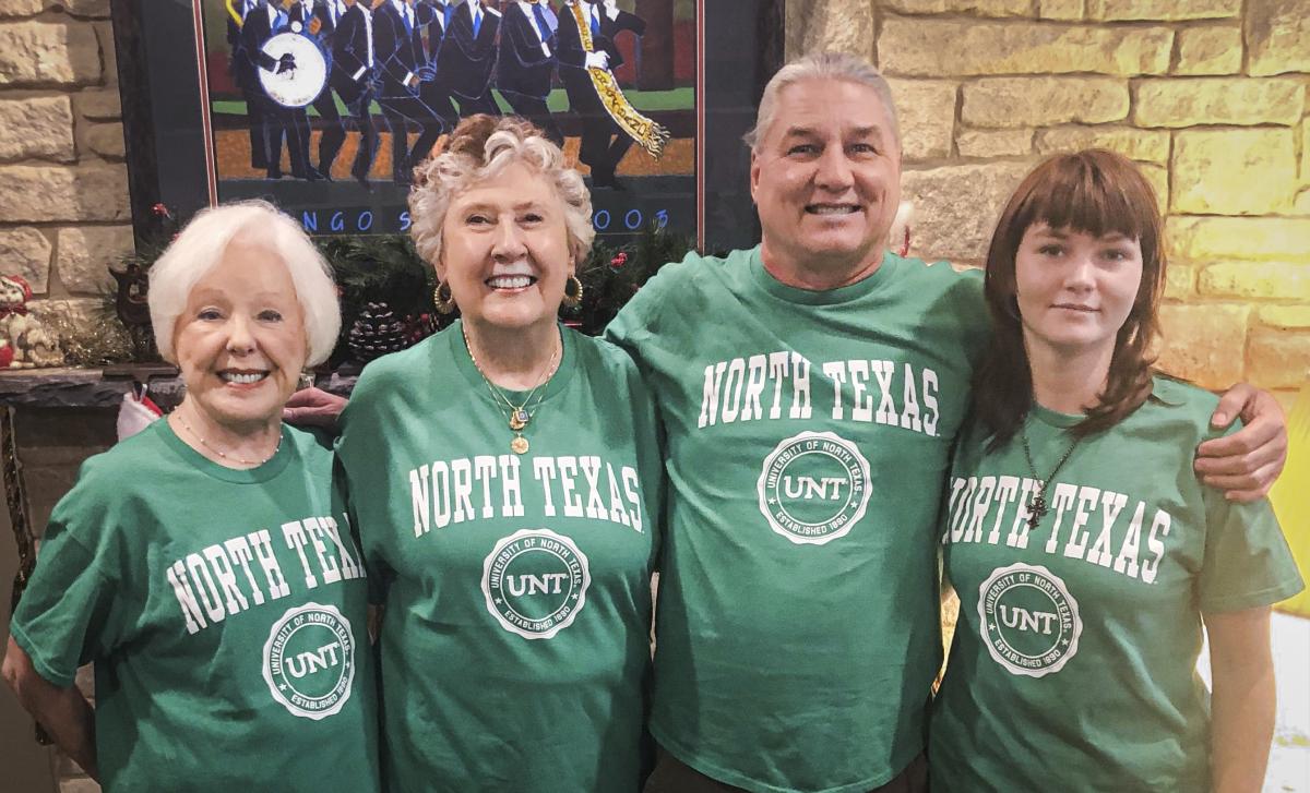 Photo of (from left to right) Jeanette Parsons, Cynthia Hawkins-Bowland, Jay Norris and Sara “Eden” Norris wearing green T-shirts with the text “North Texas.” 
