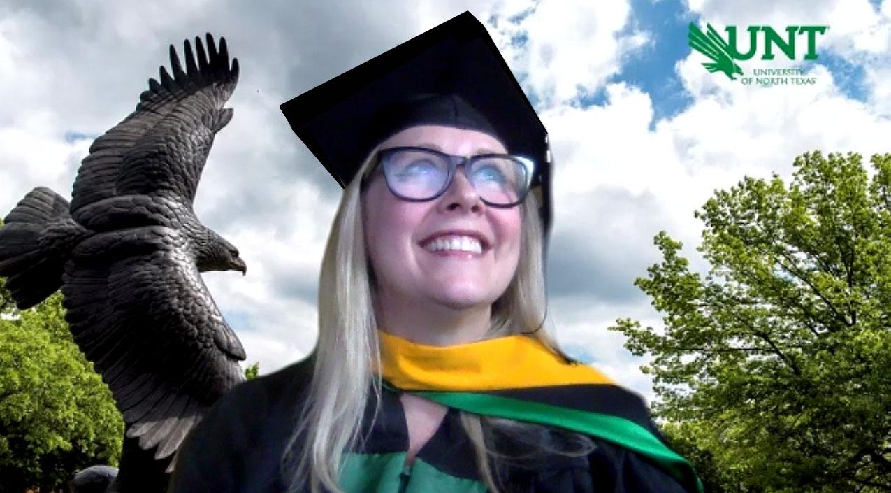 Melisa Brown in front of the bronze eagle on the UNT campus.