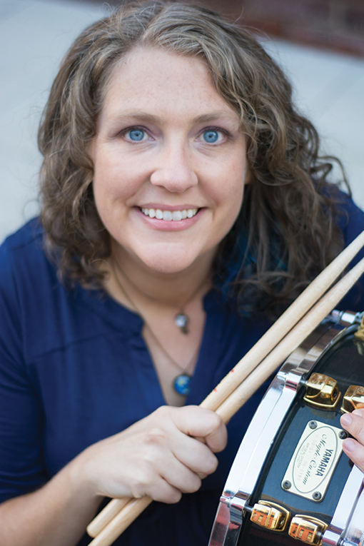 Michelle Schusterman holding a snare drum and drumsticks