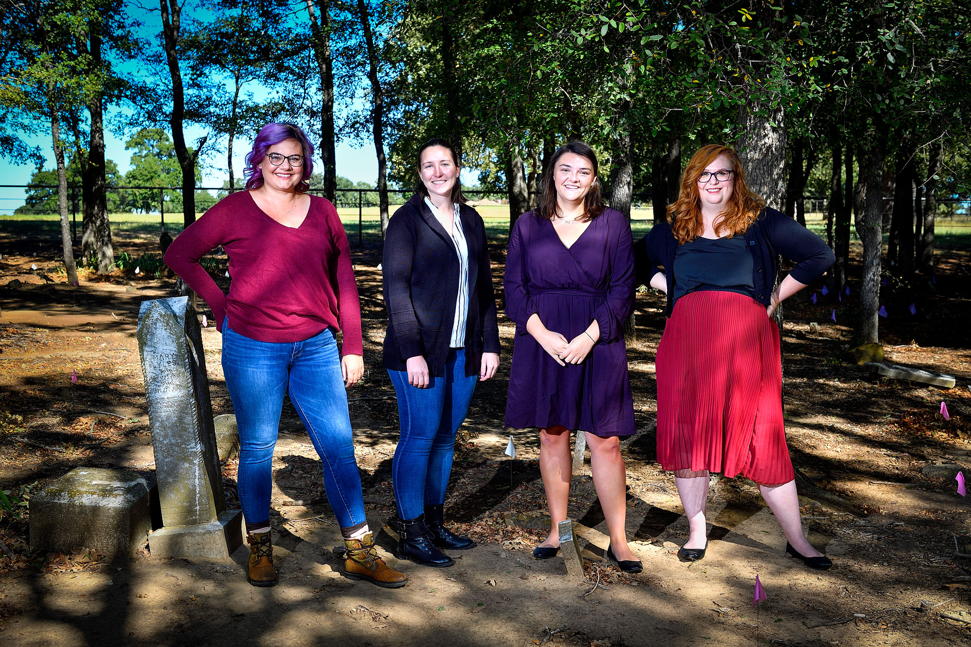 From left, Emily Bowles ('18), Jessica Floyd ('18), Hannah Stewart ('17, '19 M.A.) and Micah Crittenden ('18) stand in St. John's Cemetery. The team spent more than a year uncovering information about the St. John's community.