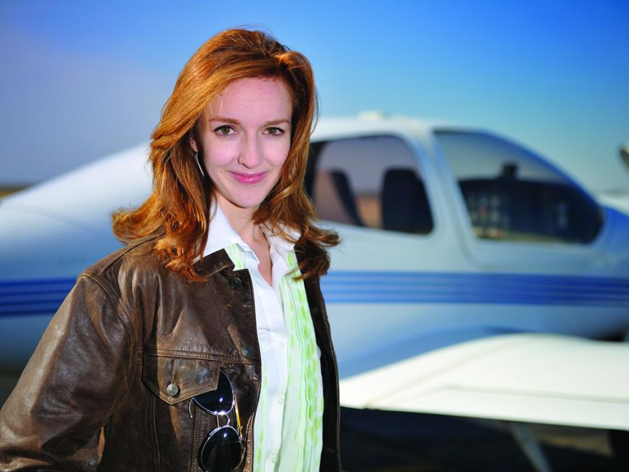 Laura Rusnok standing in front of airplane