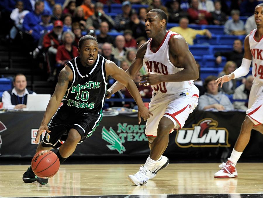 UNT's Josh White playing basketball against Western Kentucky