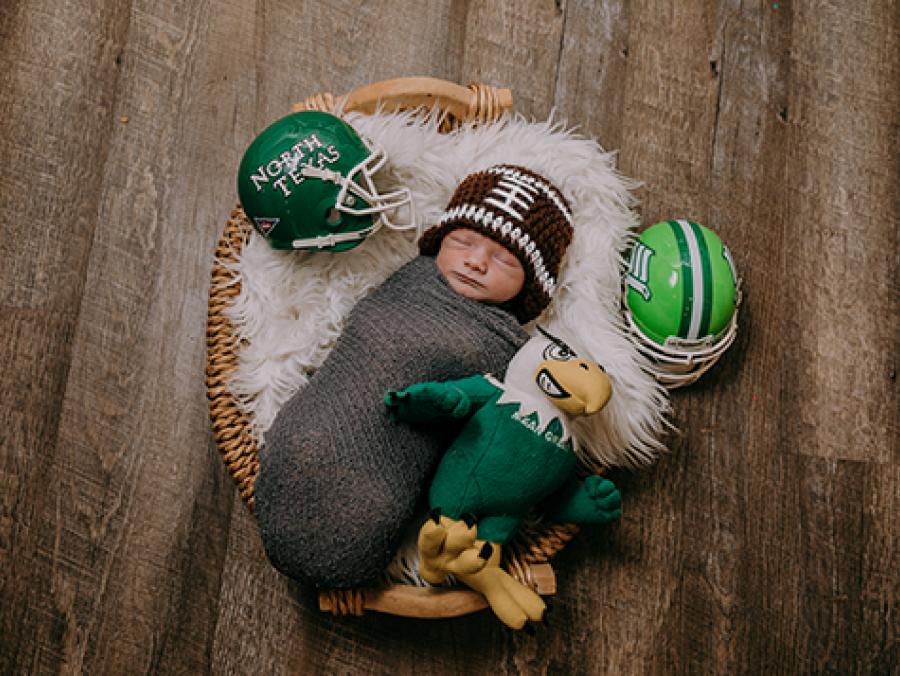 Photo of Hagan Withers surrounded by Mean Green football memorabilia