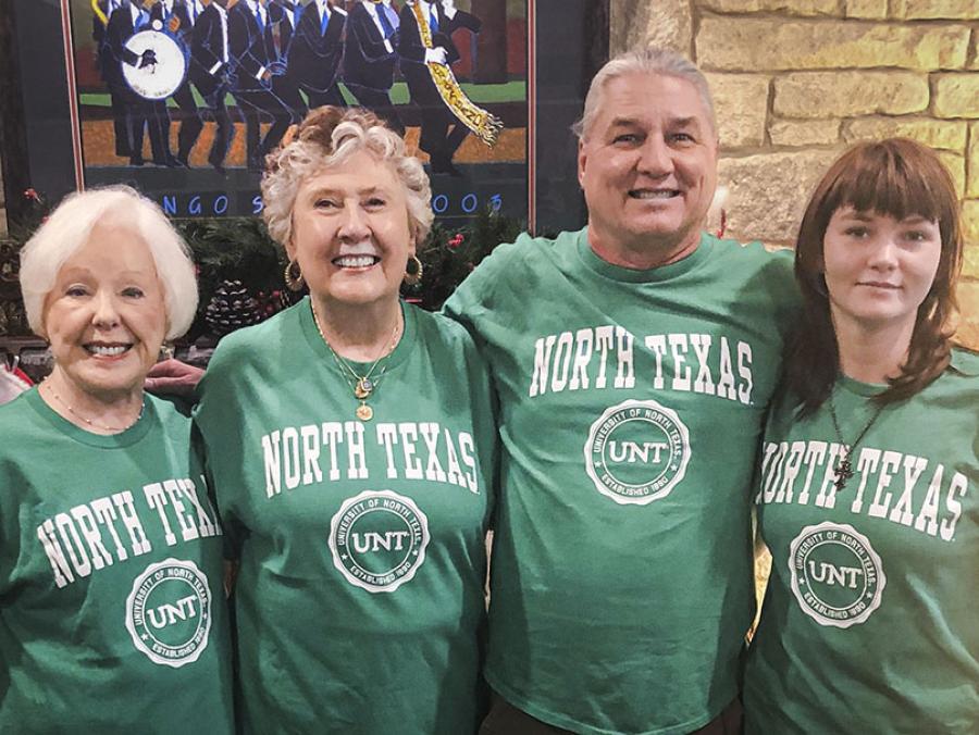 Photo of (from left to right) Jeanette Parsons, Cynthia Hawkins-Bowland, Jay Norris and Sara “Eden” Norris wearing green T-shirts with the text “North Texas.” 