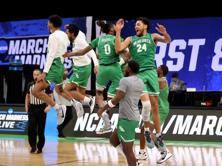 Mean Green men's basketball jumps into the air after beating Purdue in the first round of the NCAA championship.