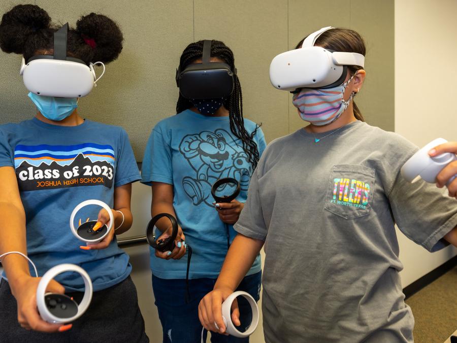 Three students wear Oculus headsets as they evaluate technology at the UNT’s Girls Surge into STEM XR Camp.