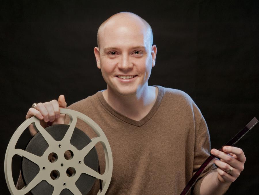 Joshua Butler holding film reel