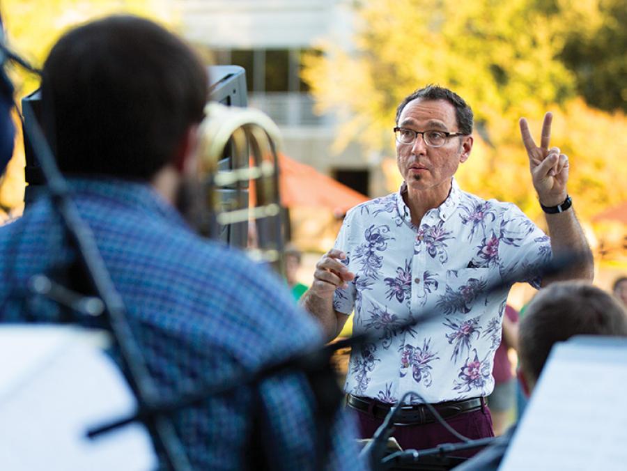 Alan Baylock conducting an outdoor performance ath the Frisco Art Walk