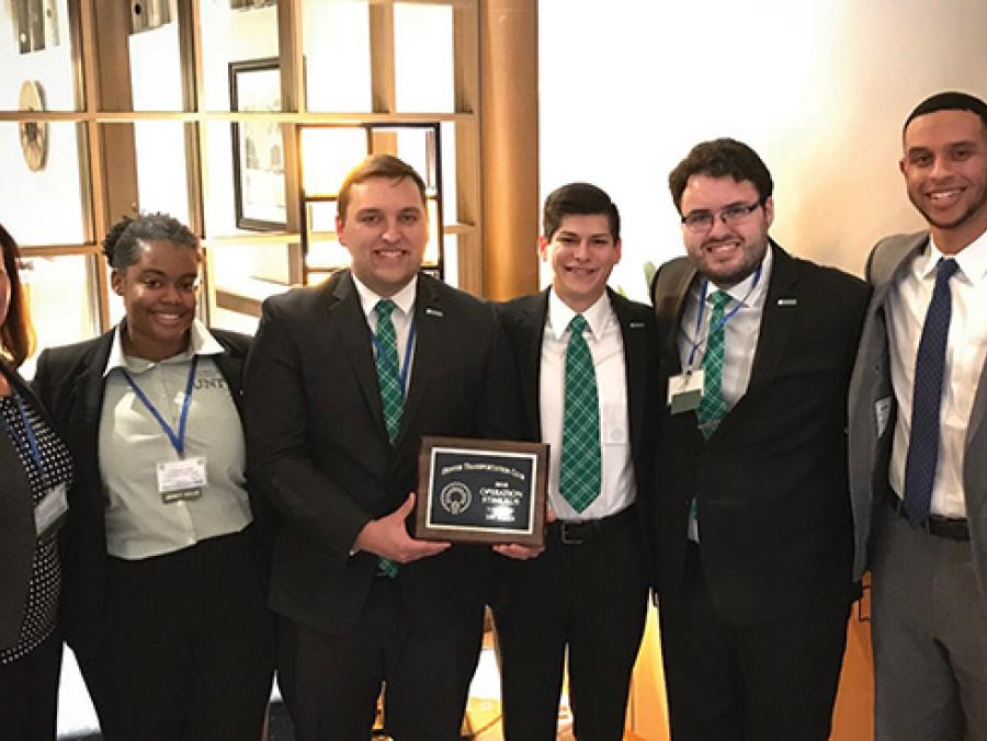 Chelsea Jones, Woodrow Weaver and Carlos Castro with junior Joshua Intondi (pictured with Julie Willems-Espinoza, associate director of UNT's Center for Logistics Education and Research, from left)