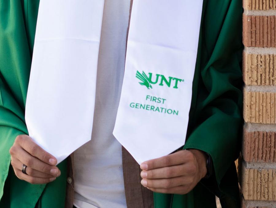 Hands hold UNT first-generation graduate stole