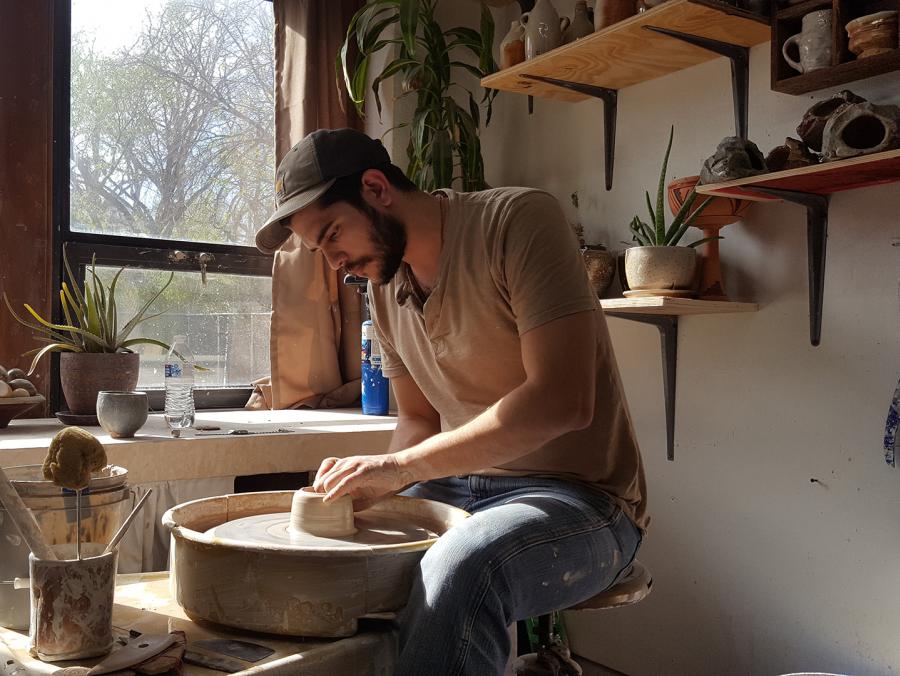 Horacio Casillas works on pottery