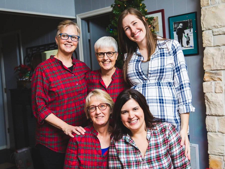 Photo of Nurre family members posed in their home, wearning plaid shirts 