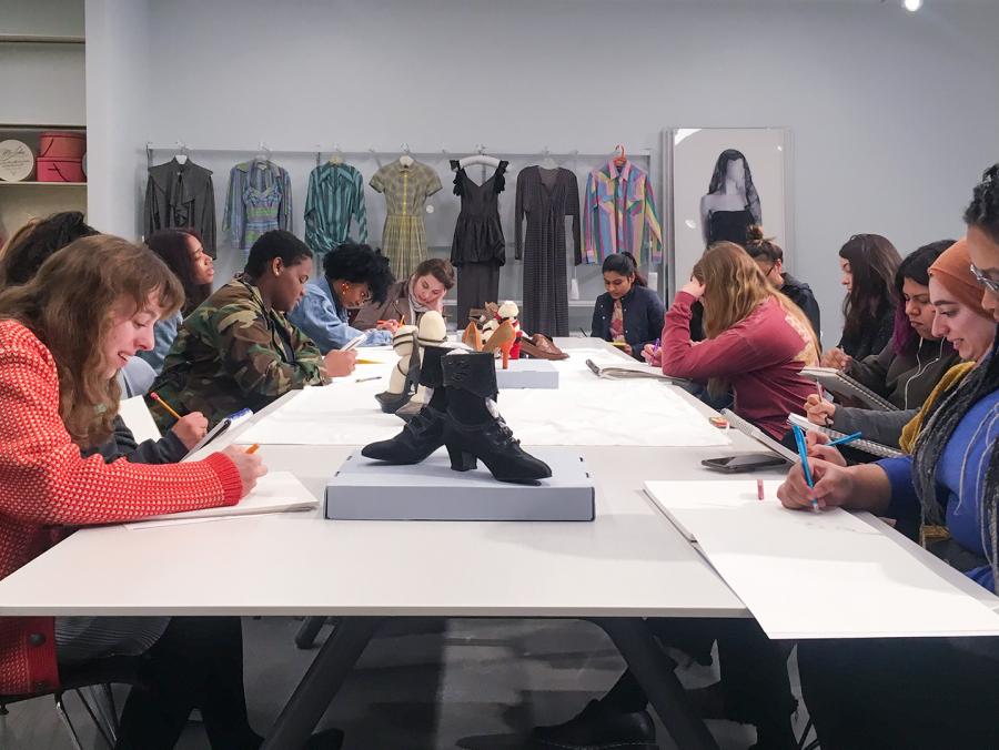 Fashion design students seated at a table