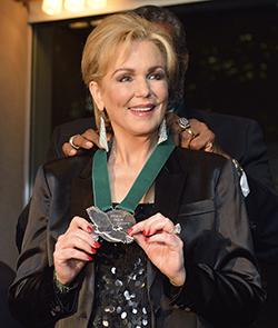 Phyllis George receiving Emerald Eagle honor